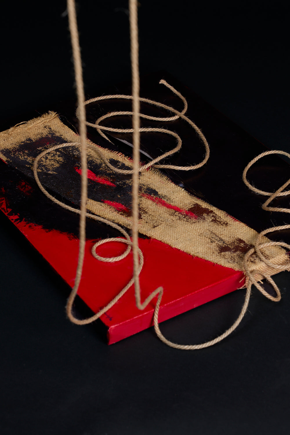 Red and black oil painting with mixed media -- natural fabric and rope on painting. Art piece by New York artist, Anne Vandycke.
