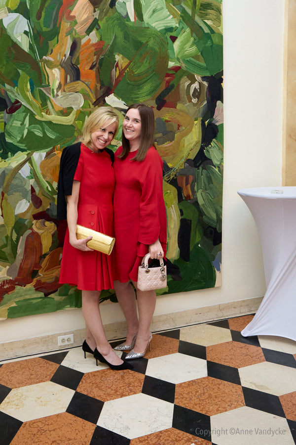 Dinner at the French Consulate in New York honoring American donors supporting the reconstruction of Notre Dame de Paris. Two women wearing red dresses.