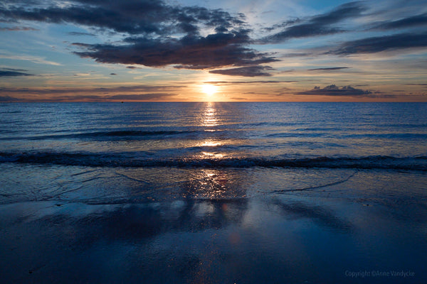 Photography by New York City Photographer, Anne Vandycke. Sunset over a calm ocean with a clear sky. Copyright 2025.