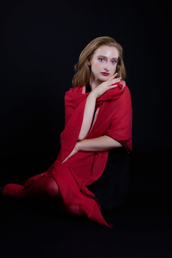 Woman wrapped in a red fabric against a black background.Studio photos by New York photographer, Anne Vandycke/Copyright 2026 ©Anne Vandycke, All rights reserved. 